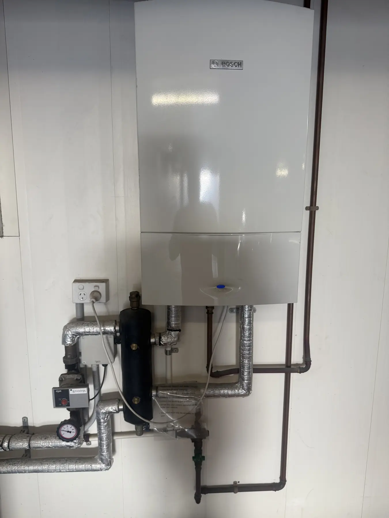 Wall-mounted hot water installation by Plumbing Dynamix